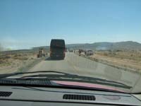 06-5_hours_later-fire_grows-one-way_pilot_car_traffic-hotshot_fire_crew_on_scene-fire_break_created_by_grader