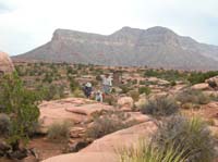 74-Neil_Richard_and_John_walking_with_scenic_views_and_composting_pit_toilet_in_background