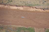 12-zoom_view_of_swift_flowing_river_with_river_rafter_and_cliff_erosion_from_1963