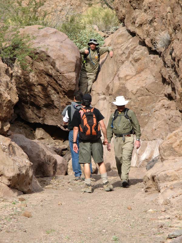 28-Chris_climbing_down_boulder_and_talking_to_others