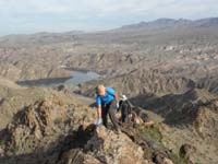 06-Lyn_and_Ken_scrambling_ridge_with_Willow_Beach_in_background