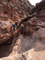 47-scrambling_the_rocks_while_passing_the_trash_filled_metal_can_being_taken_home_to_recycle-from_Laszlo