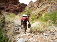 48-me_carrying_the_metal_bucket_full_of_recyclables_and_trash-from_Luba