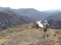 28-Laszlo_walking_on_ridge-White_Rock_Canyon_drainage_in_distance_along_Colorado_River