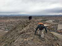 08-looking_back_to_group_on_exposed_ridgeline_with_The_Strip_in_distance