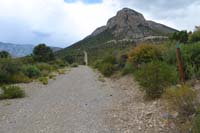 63-looking_back_to_approaching_storm_clouds,Step_Ladder_trail_marker_to_R