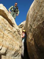 05-Lori_trying_to_squeeze_through_while_Greg_watches_after_going_another_way