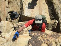 33-Ali_climbing_up_the_final_rock_to_the_peak