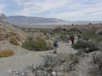 48-Luba_Courtney_and_Ed_in_drainage_heading_back_to_vehicle-Sheep_Mountains_in_distance