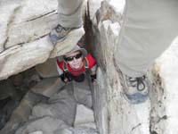 06-Daddy_takes_a_picture_of_his_feet_for_reference_as_Kenny_climbs_through_a_small_tunnel