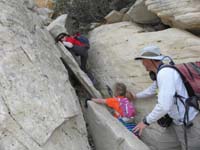 08-Kenny_scrambles_while_Daddy_helps_Sarah-she's_used_to_rock_climbing_in_a_gym