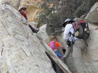 09-Daddy_uses_his_leg_as_an_extra_climbing_hold_for_Sarah-Kenny_watches_and_gives_direction