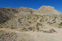 07-continuing_along_rough_dirt_road_to_L,bike_trail_to_R-Lonely_Pinyon_Mt_in_distance