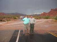05-Brad_and_I_on_tour-flood_lowering_after_4_min,compare_to_picture_02_and_note_clump_of_debris_at_Brad's_feet