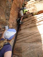 22-Harlan_leading_another_climb-5.7_rated_crack-his_right_hand_on_trimmed_bolt_in_rock_ledge