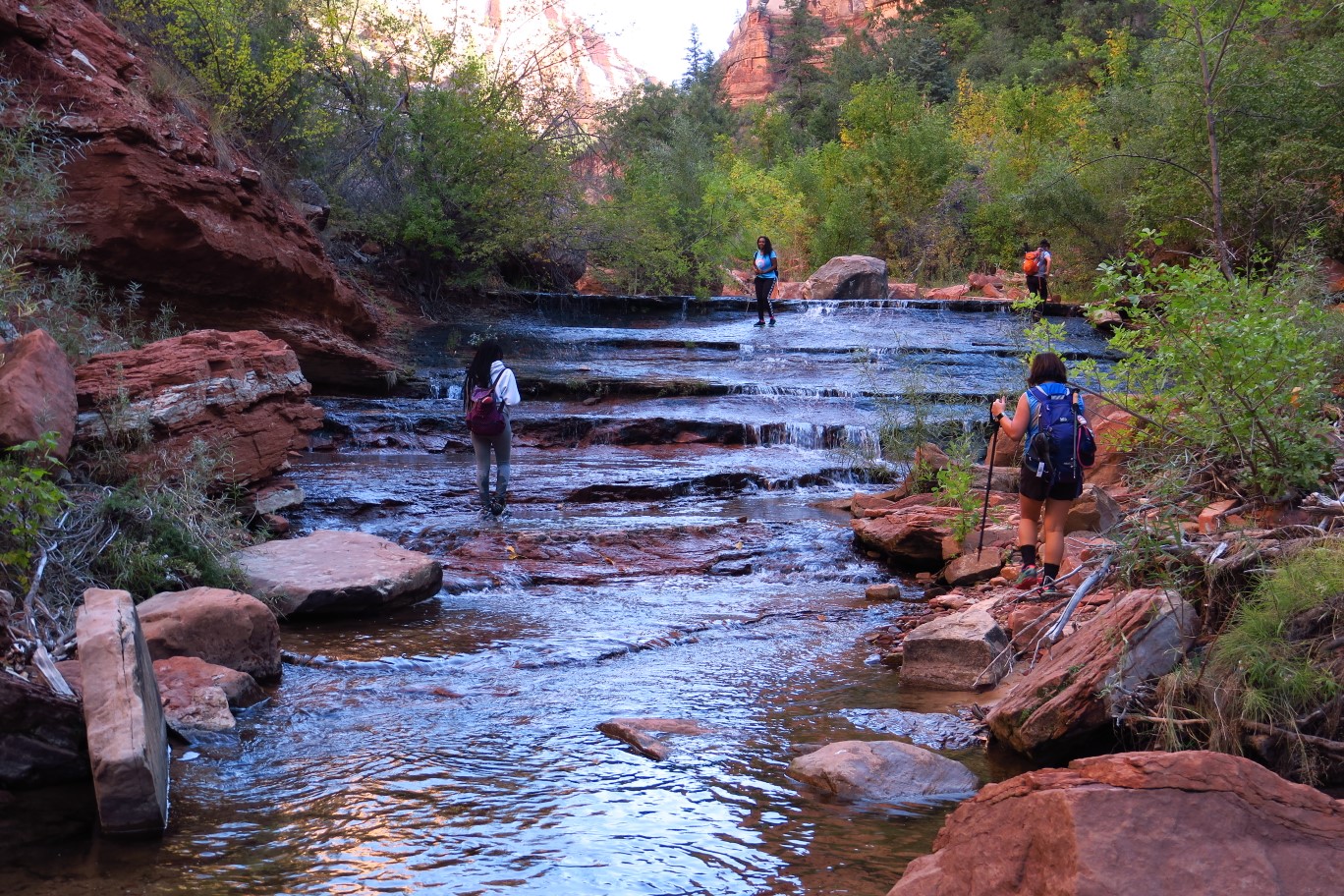 052-group_walking_up_cascading_waterfall_along_the_stream