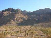 02-facing_east_with_glare_from_sun_a_little_to_south-wash_we_enter_after_traveling_2_miles_across_open_desert