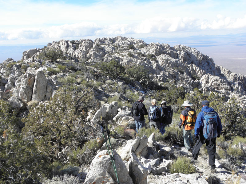 51-group_heading_back_down_with_view_of_Spirit_Mountain_peak